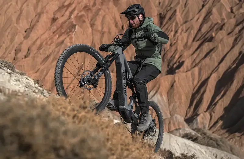 Riding the Amflow PR up a steep trail in the mountains