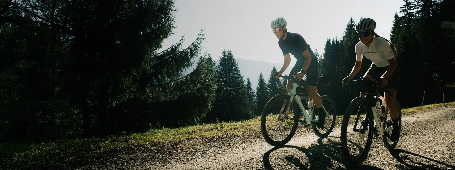 Two gravel cyclists riding with a front bikepacking bag