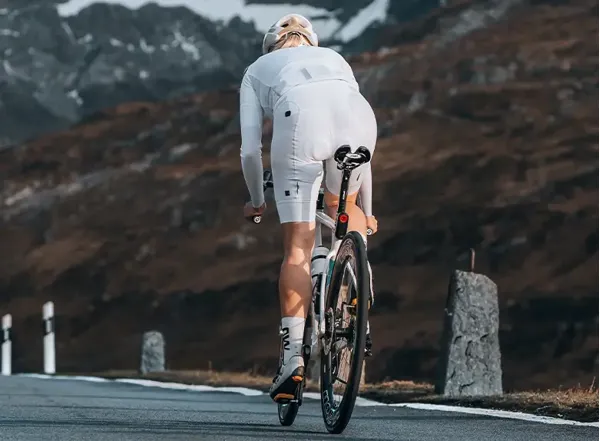 cycist riding in white kit including bib shorts