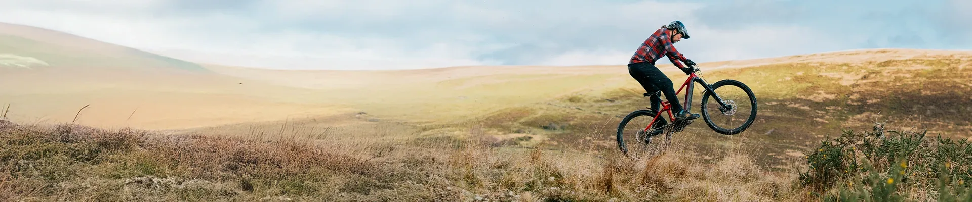 mountain bike rider in the Welsh hills jumping