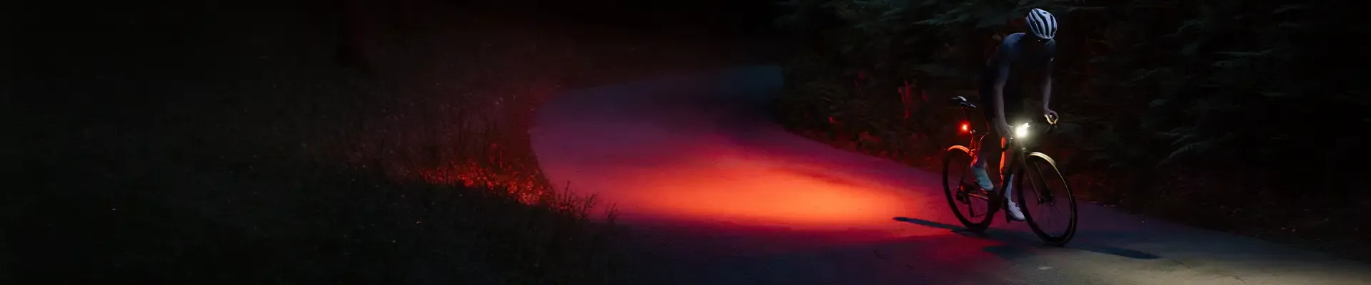 Cyclist riding at night with a bright front light