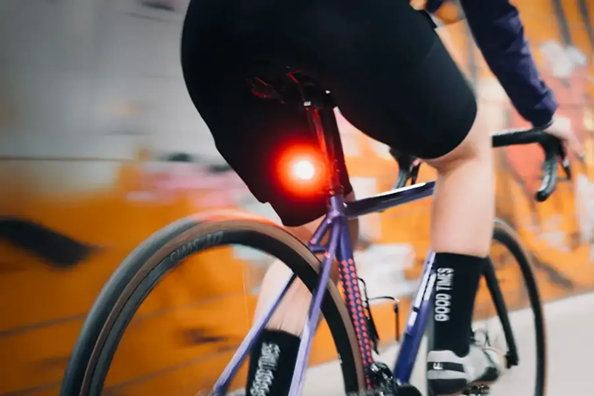 Bright rear bike light mounted beneath a cyclist&rsquo;s saddle