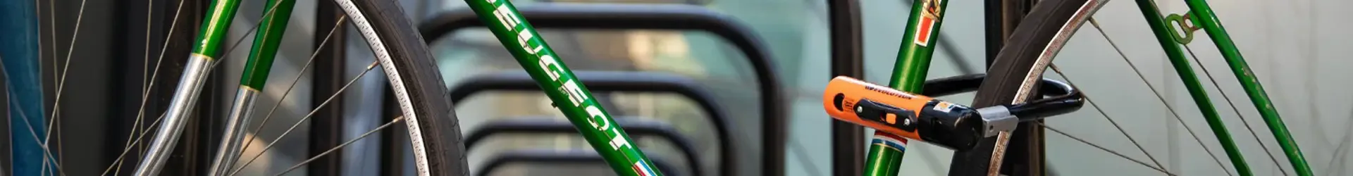 Classic bicycle secured at a cycle stand with a D-lock