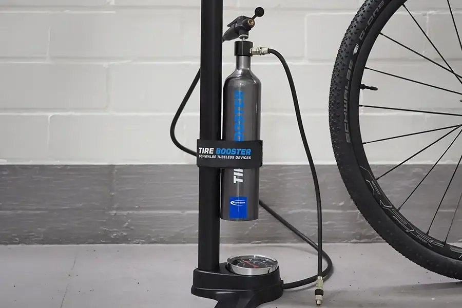 Schwalbe Tyre Booster tubeless inflator strapped to a track pump
