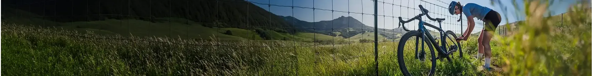 pumping up bike tyres at the side of a mountain road