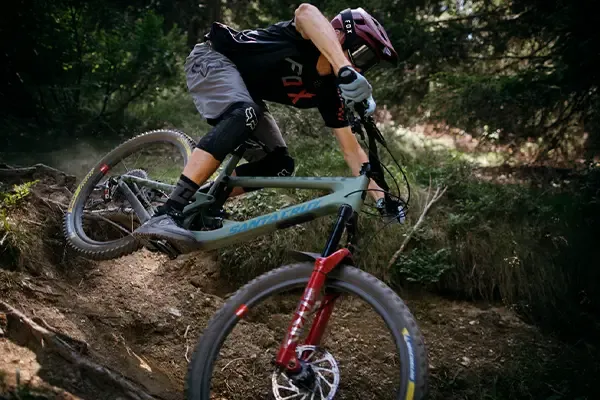 Fox Mountain bike knee pads worn while riding a steep technical woodland trail