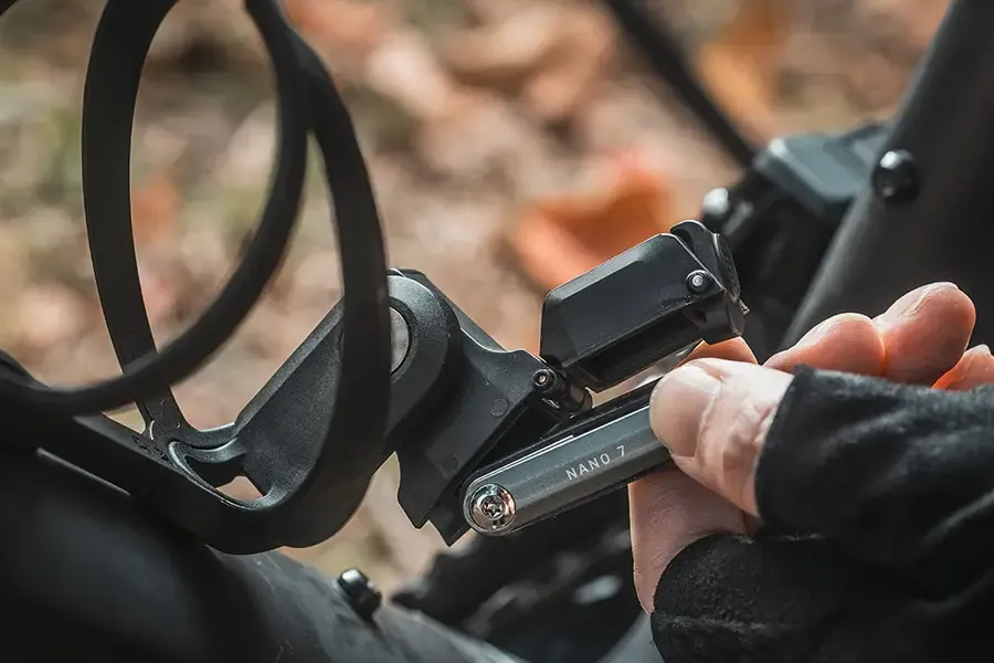 Multi-tool being removed from a holder beneath a bottle cage.