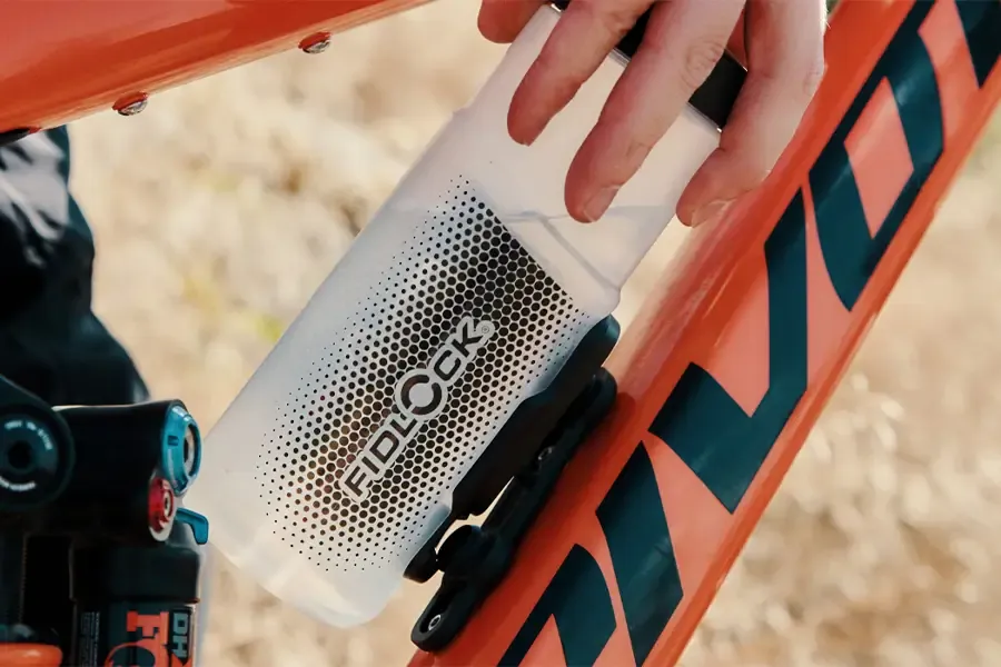 Fidlock bottle and magnetic mounting base on a mountain bike frame.