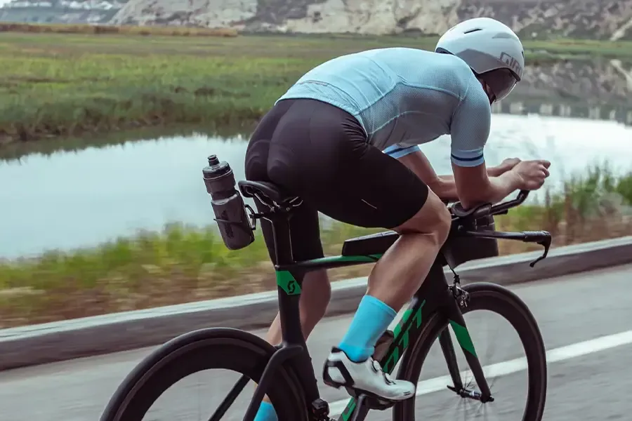 Triathlete riding with a bottle mounted behind the saddle.