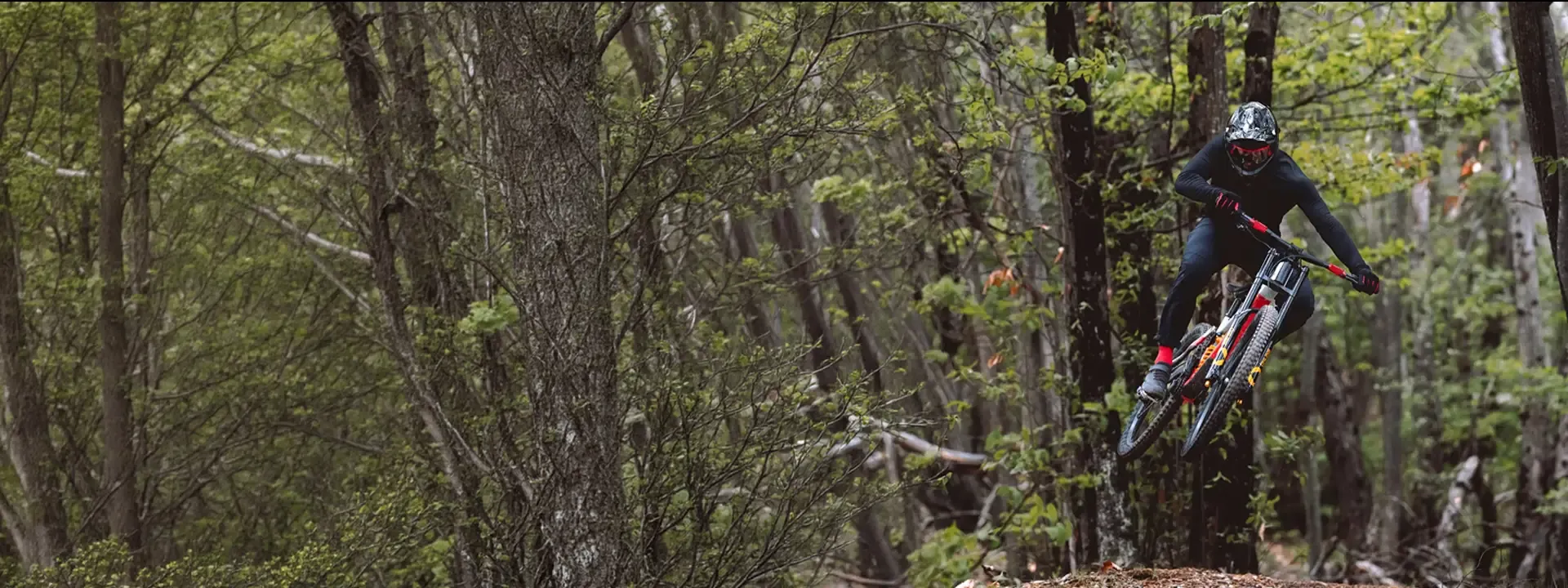 Downhill mountain biker riding a woodland trail &ndash; Brembo GR-Pro braking for gravity riding