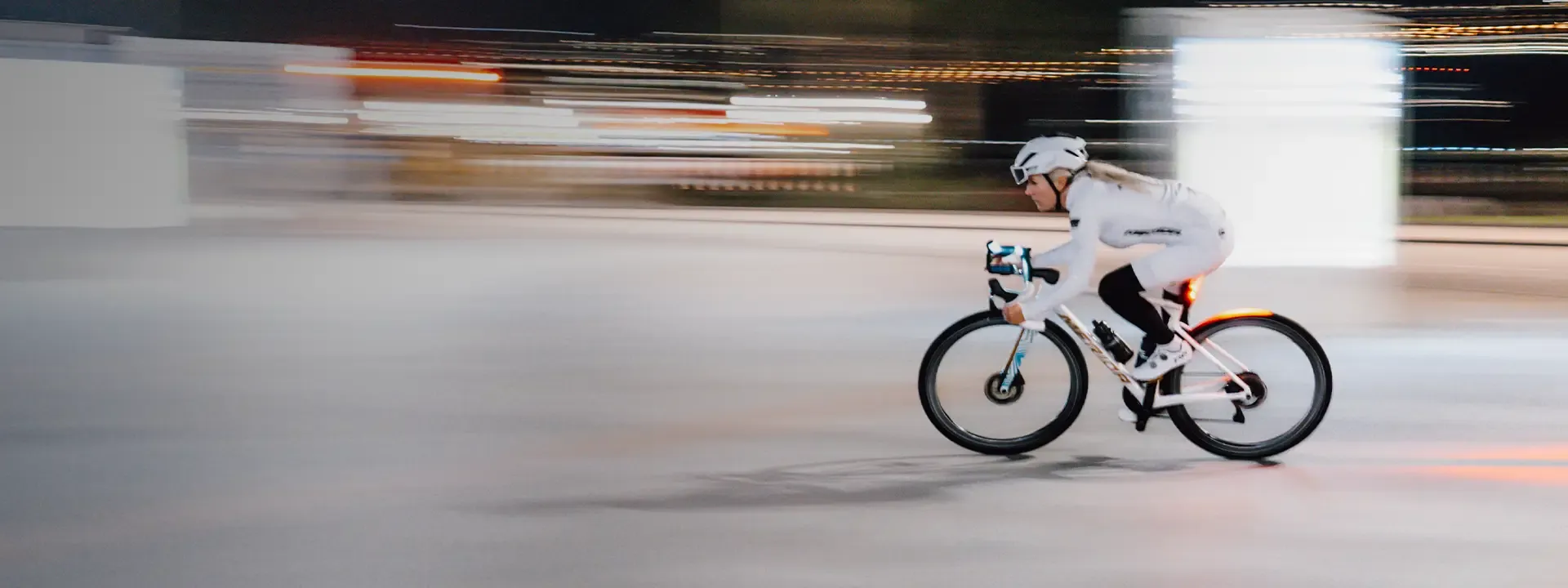 Road cyclist riding at speed wearing cycling leg warmers during cool weather road riding