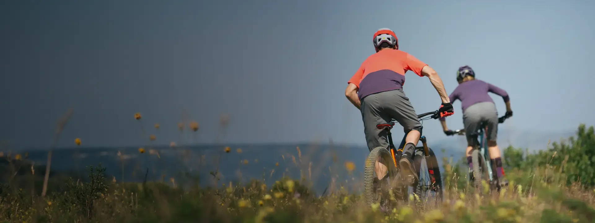 Mountain bikers riding coastal trails wearing baggy mountain bike shorts and trail clothing