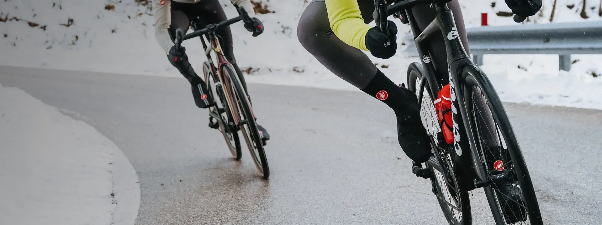Road cyclists riding in cold wet winter conditions wearing protective cycling overshoes