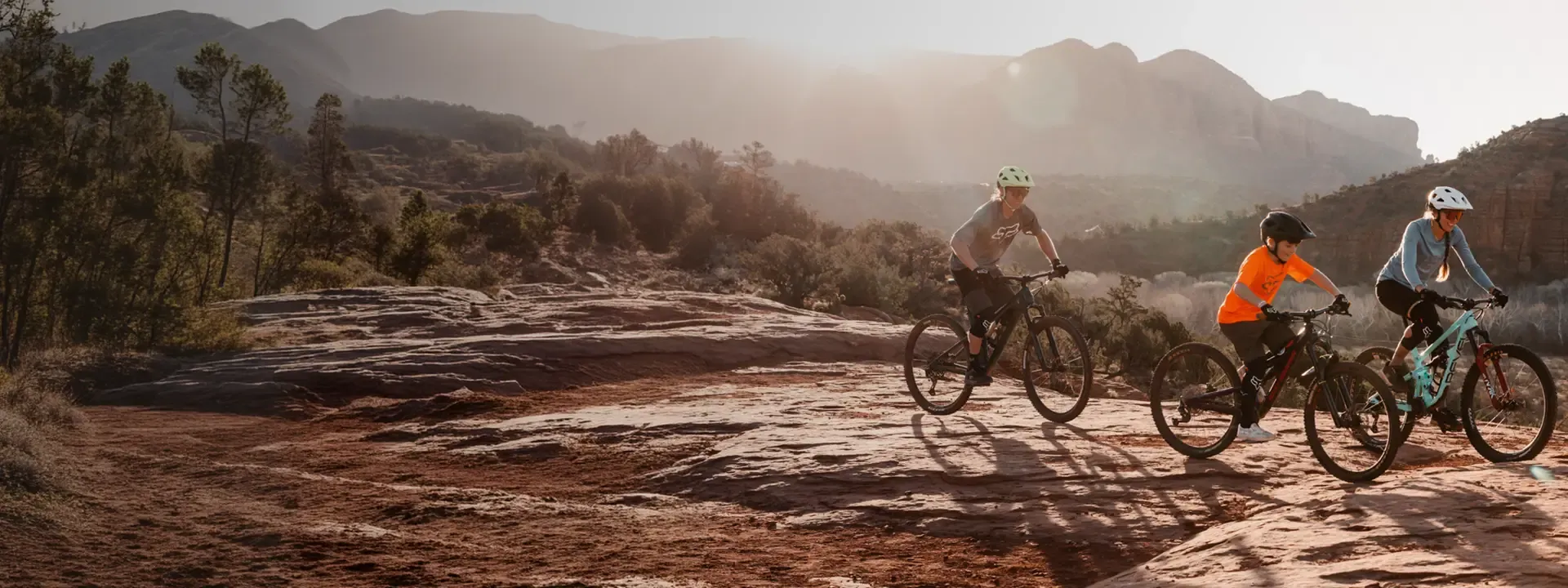 Cyclists riding in mountain terrain wearing cycling clothing