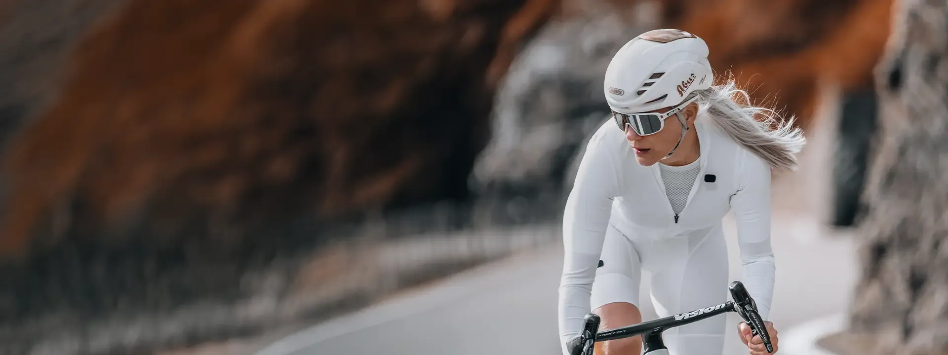 Female road cyclist wearing a lightweight cycling base layer during cool weather riding