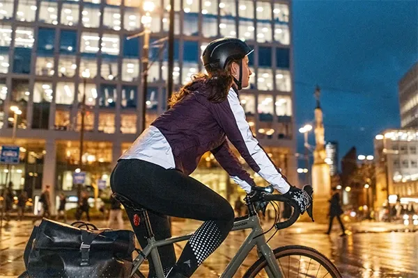 Female cyclist riding in an urban setting wearing upper body commuting and leisure cycling clothing