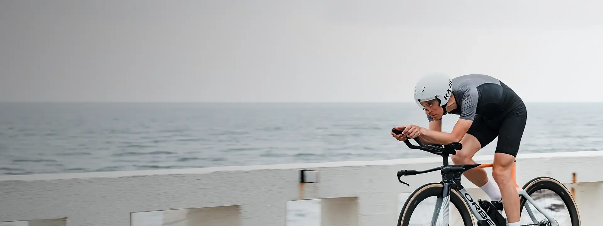 Triathlete riding in an aerodynamic tri suit during time trial style cycling