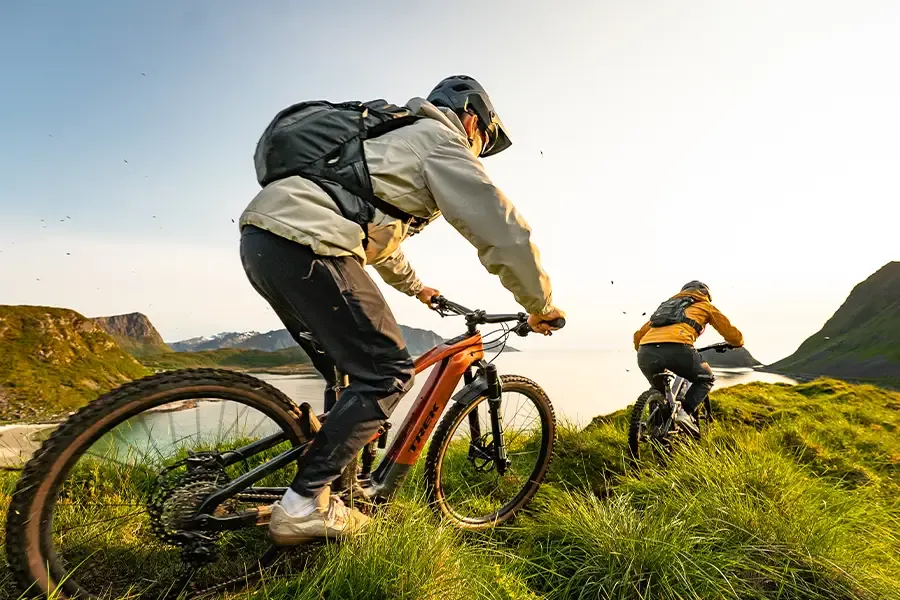 Two mountain bike riders onscenic coast trail wearing mtb backpacks