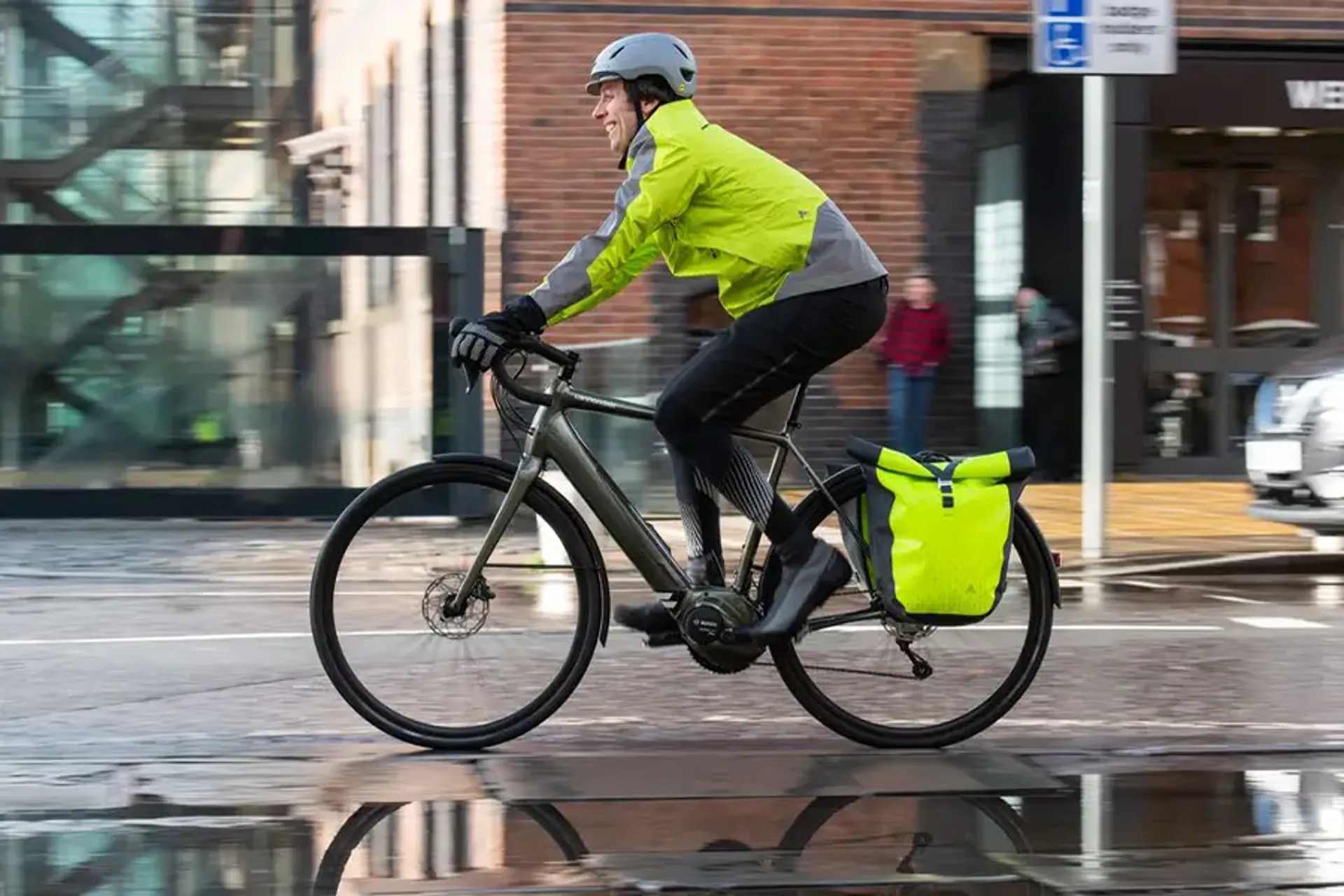 Riding a commuter bike fitted with hi-viz panniers on a wet day in the city