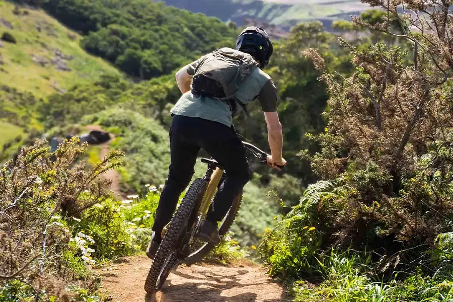 Mountain biker carrying a riding pack on the trail