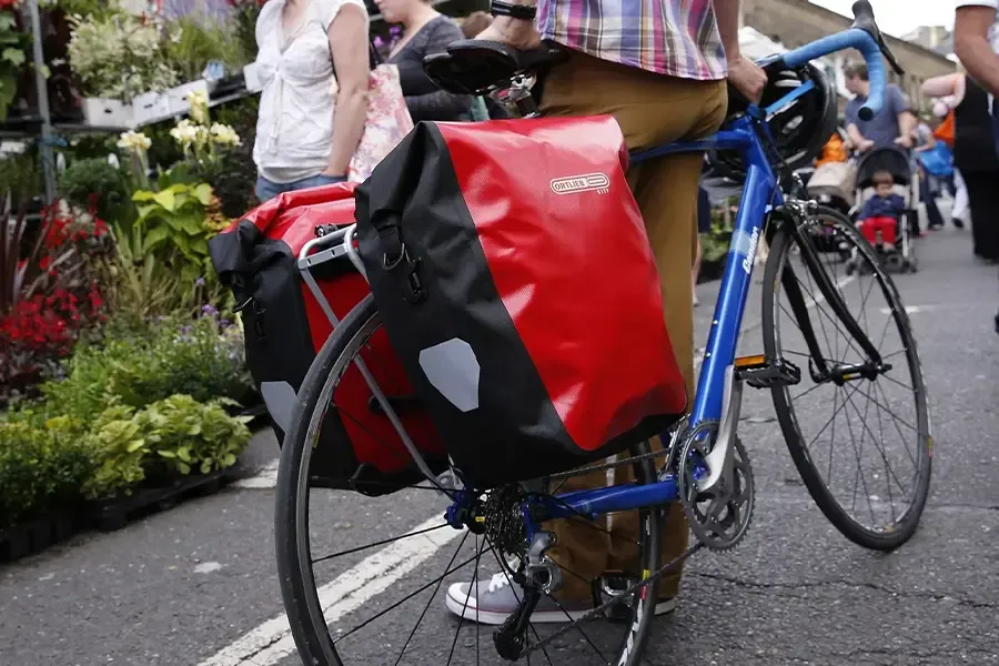 Ortlieb pannier bags fitted to a rear bicycle rack in an urban setting