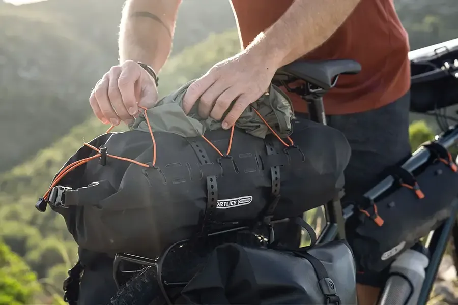 Ortlieb rack bag with bungee straps mounted on top of a rear bicycle rack