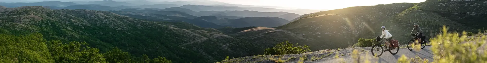 Cyclists with bags and luggage on their bikes on an adventure ride in the hills