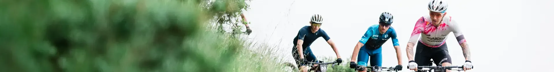 Three XC Mountain bikers wearing cycling eyewear on a cross-country race