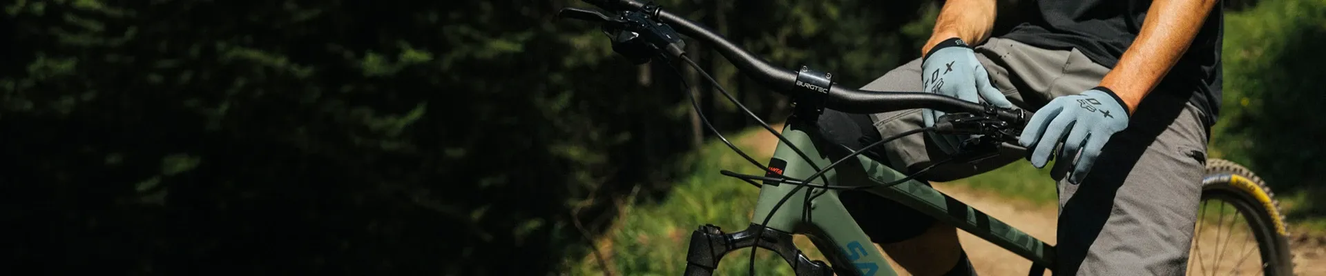 Cyclist wearing gloves while riding on mixed terrain