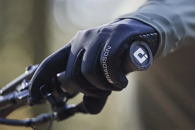 Close-up of a cyclist&rsquo;s gloved hand gripping handlebars