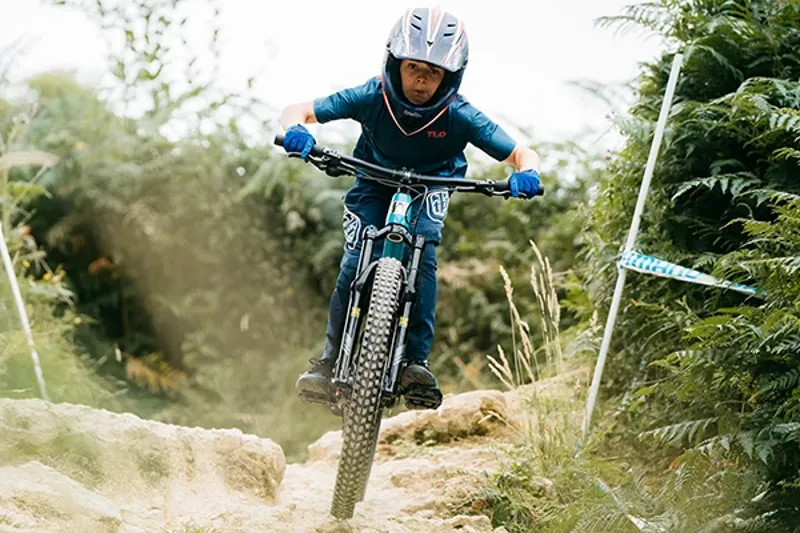 Young mountain bike rider wearing kids&rsquo; cycling gloves