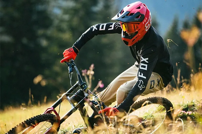 Mountain biker wearing Fox full-finger gloves on a downhill track