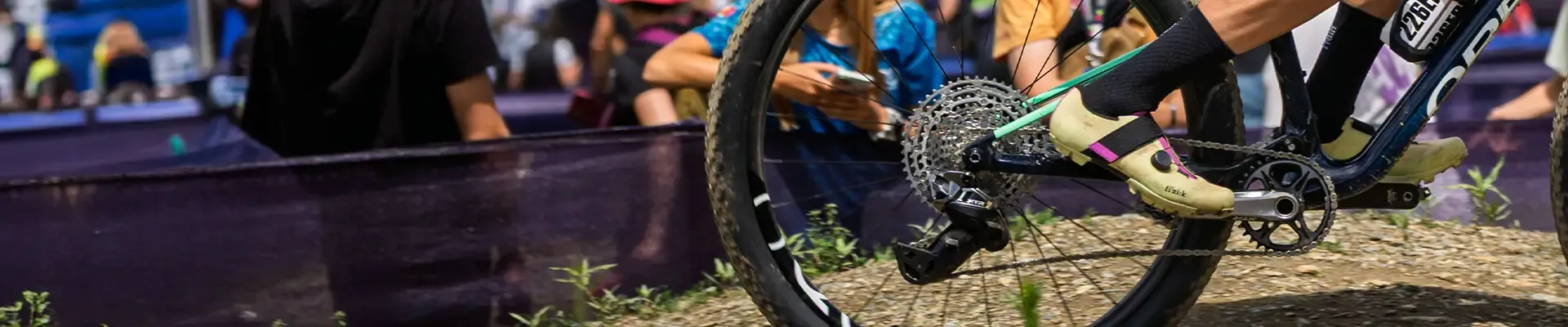 XC MTB racer wearing Fizik clipless cycling shoes and cycling socks riding detail