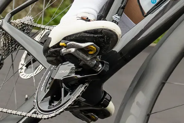 detail of clipless road shoe clipped in to shimano SPD-SL pedal while riding