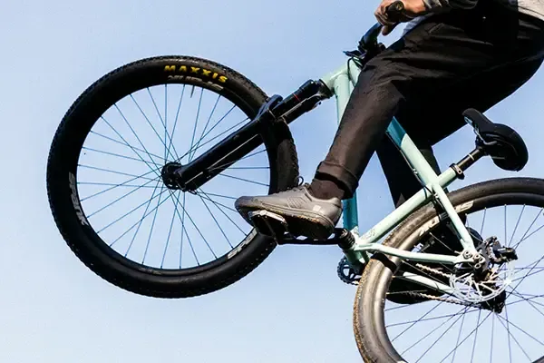 Dirt jump rider wearing Fox Union Flat MTB shoes on flat pedals