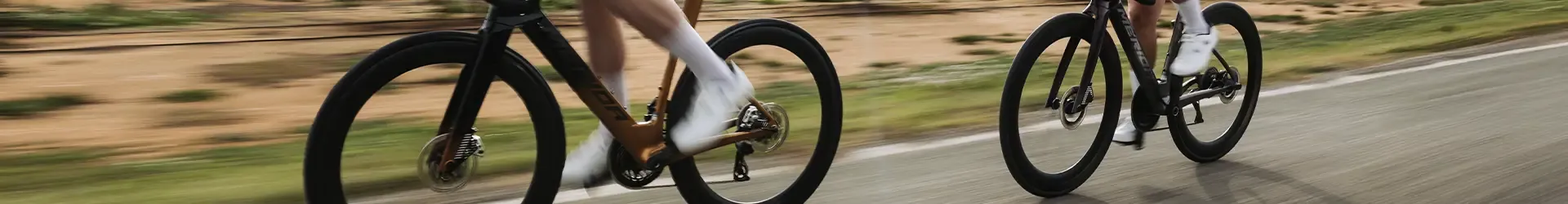 Road cyclists riding fast detail of pedal motion with white shoes