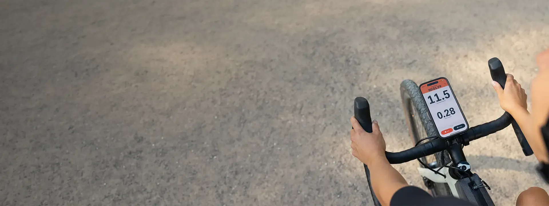 Cyclist using a smartphone mounted centrally on drop handlebars