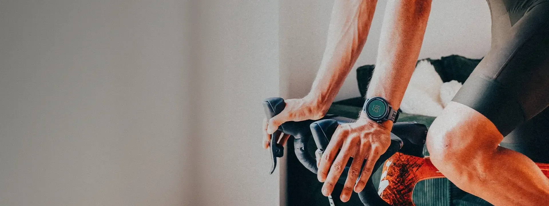 Cyclist wearing a sports watch while riding on drop handlebars