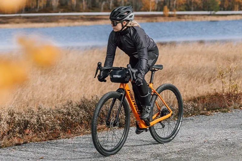 Woman riding an electric gravel bike on a scenic route