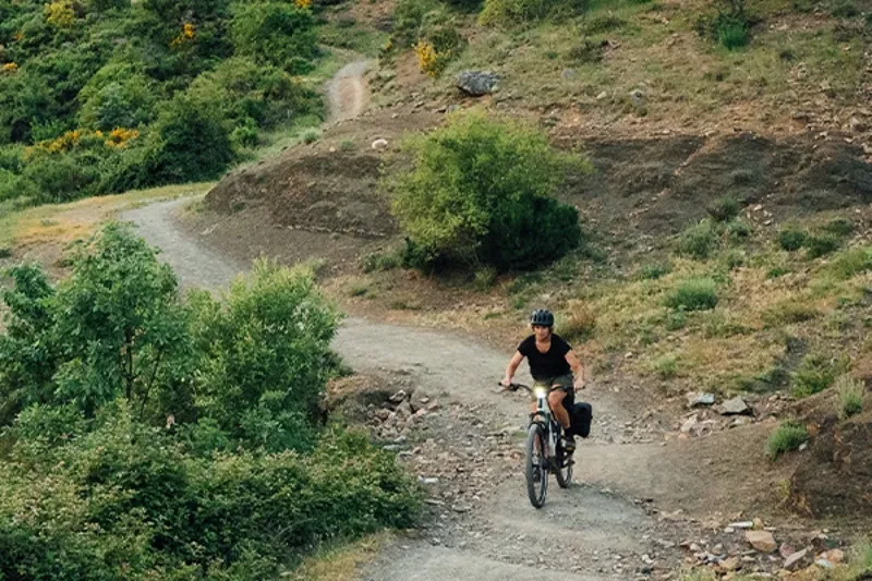 Riding an electric bike along a winding gravel track