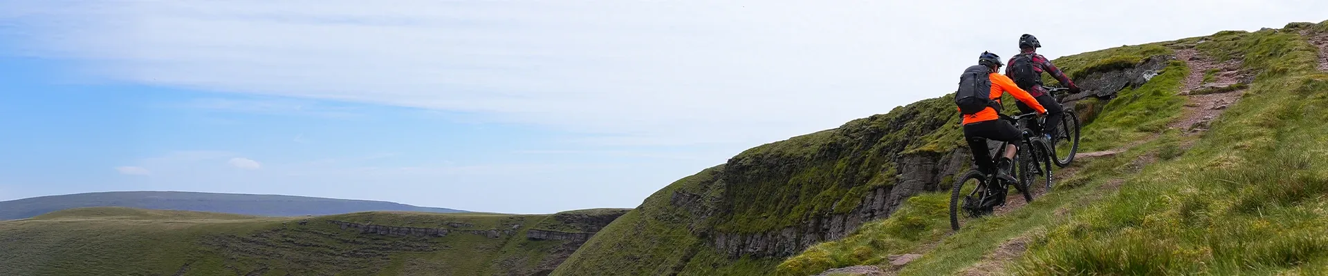 Rider climbing a trail on an electric mountain bike