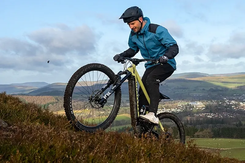 Rider climbing a trail on a Marin electric mountain bike