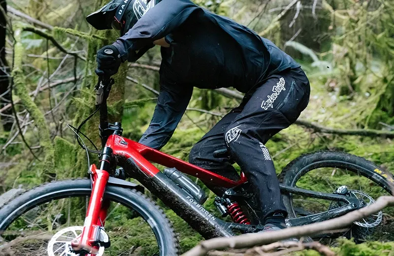 Forbidden Dreadnought bike leaned into a steep rocky corner showing close up frame and fork detail