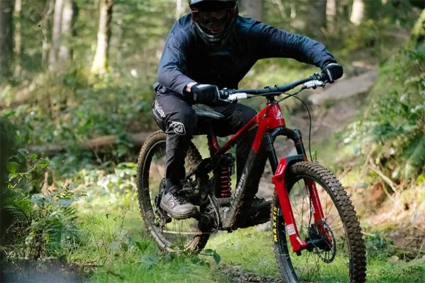 Forbidden Dreadnought E riding fast through corner showing suspension and frame detail
