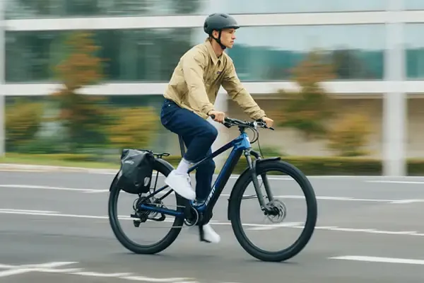 Rider commuting on a Giant Talon E+ EX equipped electric bike
