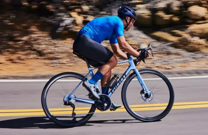 Cyclist riding Giant TCR, blue frame clour and kit