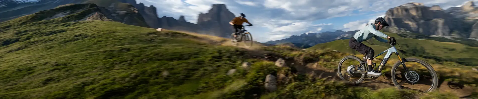 Riders exploring mountain trails on Giant Trance Advanced E+ bikes