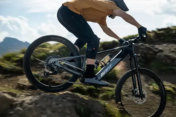 Giant Trance Advanced E+ being ridden over rocky terrain