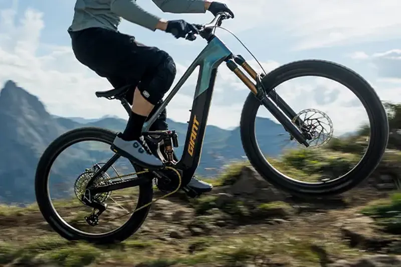 Rider climbing a rocky trail on a Giant Trance Advanced E+