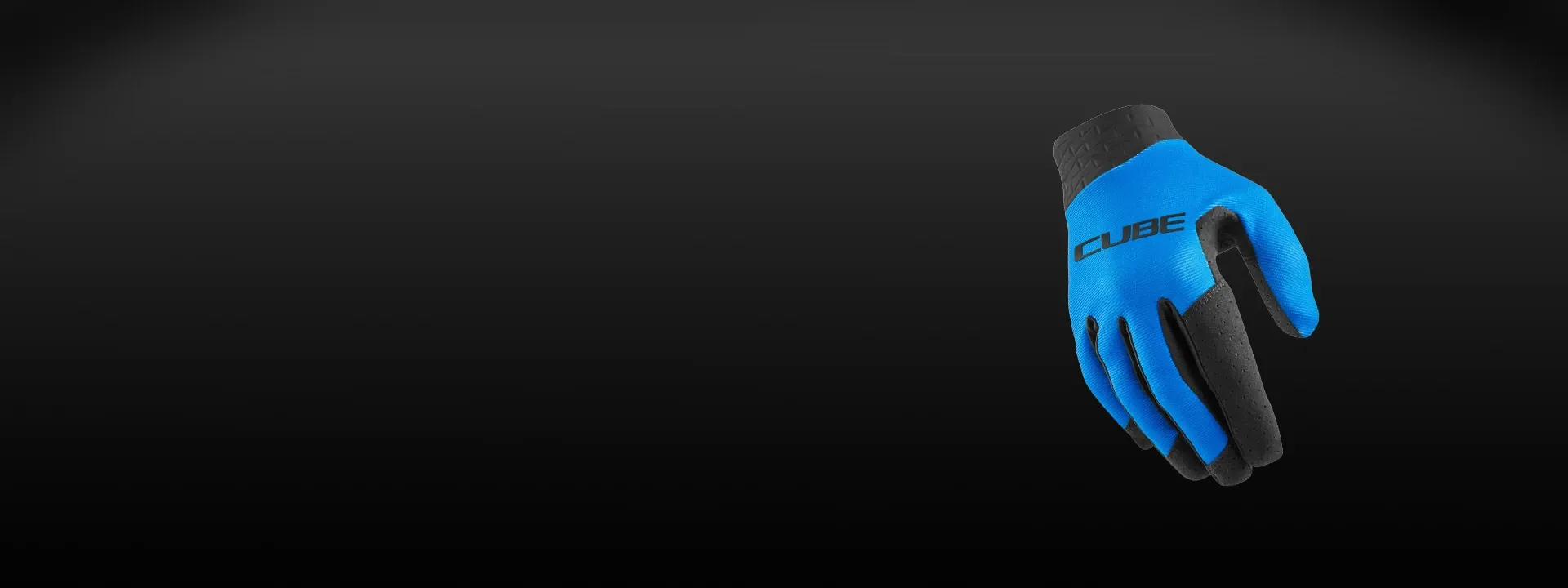 Cyclist wearing Cube gloves while riding off-road